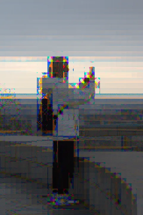 A waterside post with coloured fringes along its pale silhouette