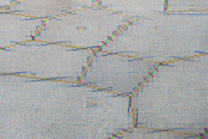 Pale brickwork with fine coloured patterns along the mortar